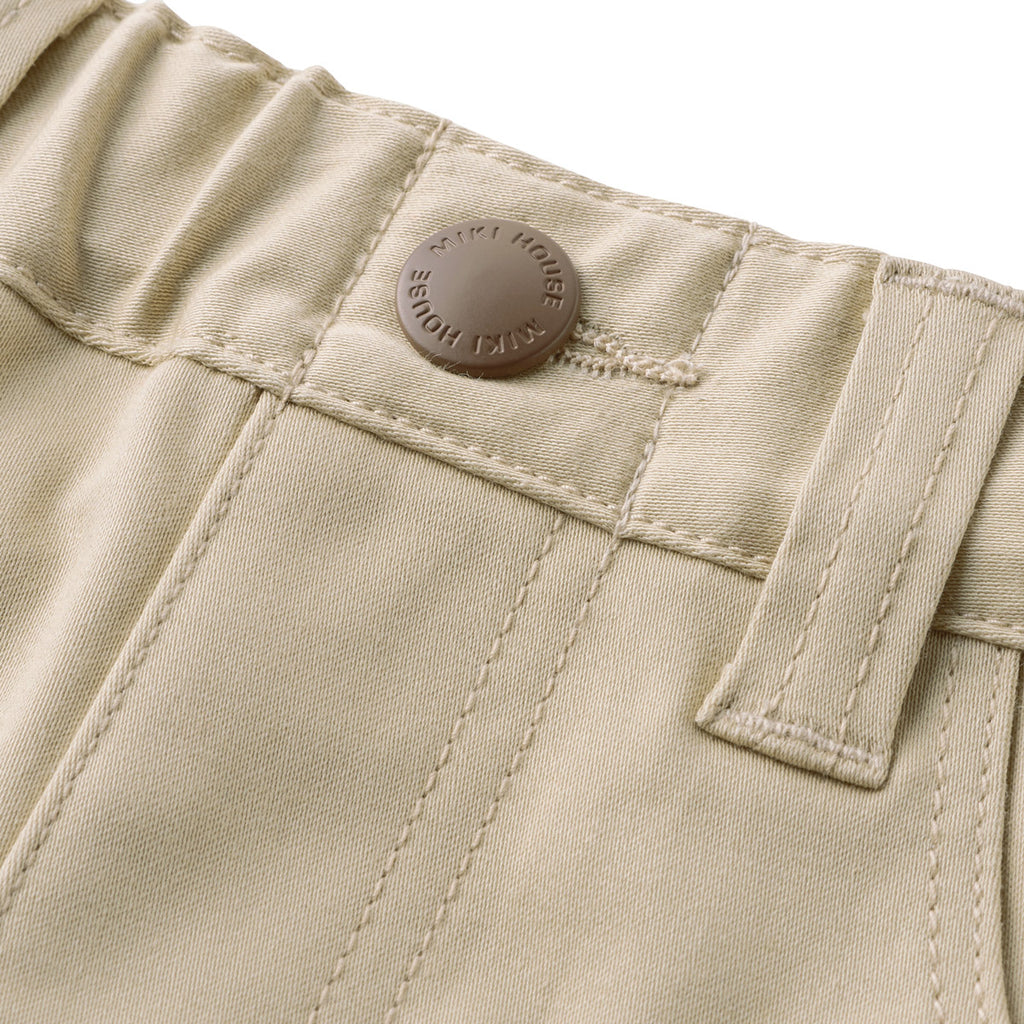 PANTALON BEIGE AVEC REVERS À CARREAUX